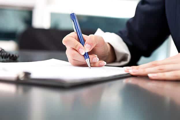 Image of corporate woman signing a legal contract 